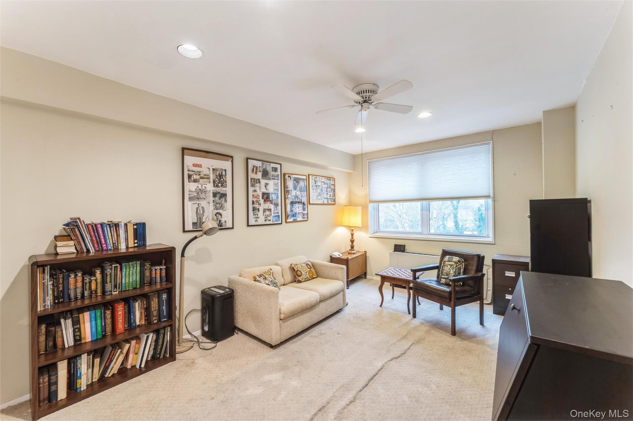 1 Kensington Gate, Unit PH9 Great Neck, NY 11021 - Photo 10 of 17 a living room with furniture and a book shelf