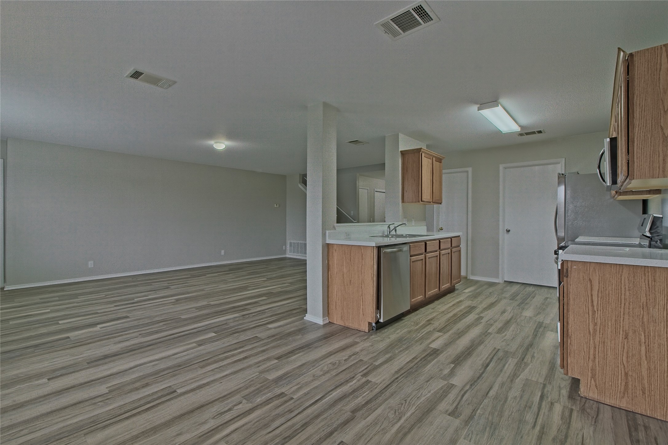 232 Brickyard Lane Jarrell, TX 76537 - Photo 13 of 31 An open-concept living space with resilient flooring transitions seamlessly into a well-appointed kitchen.