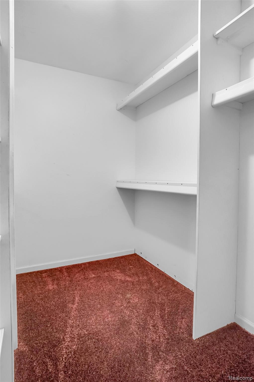 1431 East Commerce Road Commerce Township, MI 48382 - Photo 20 of 27 Spacious closet with dark colored carpet