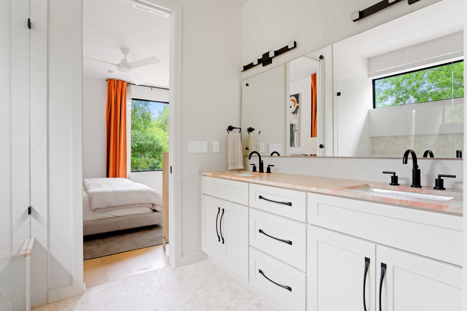 4911 Duval Street Austin, TX 78751 - Photo 16 of 33 a en suite bathroom with a sink a window and a mirror