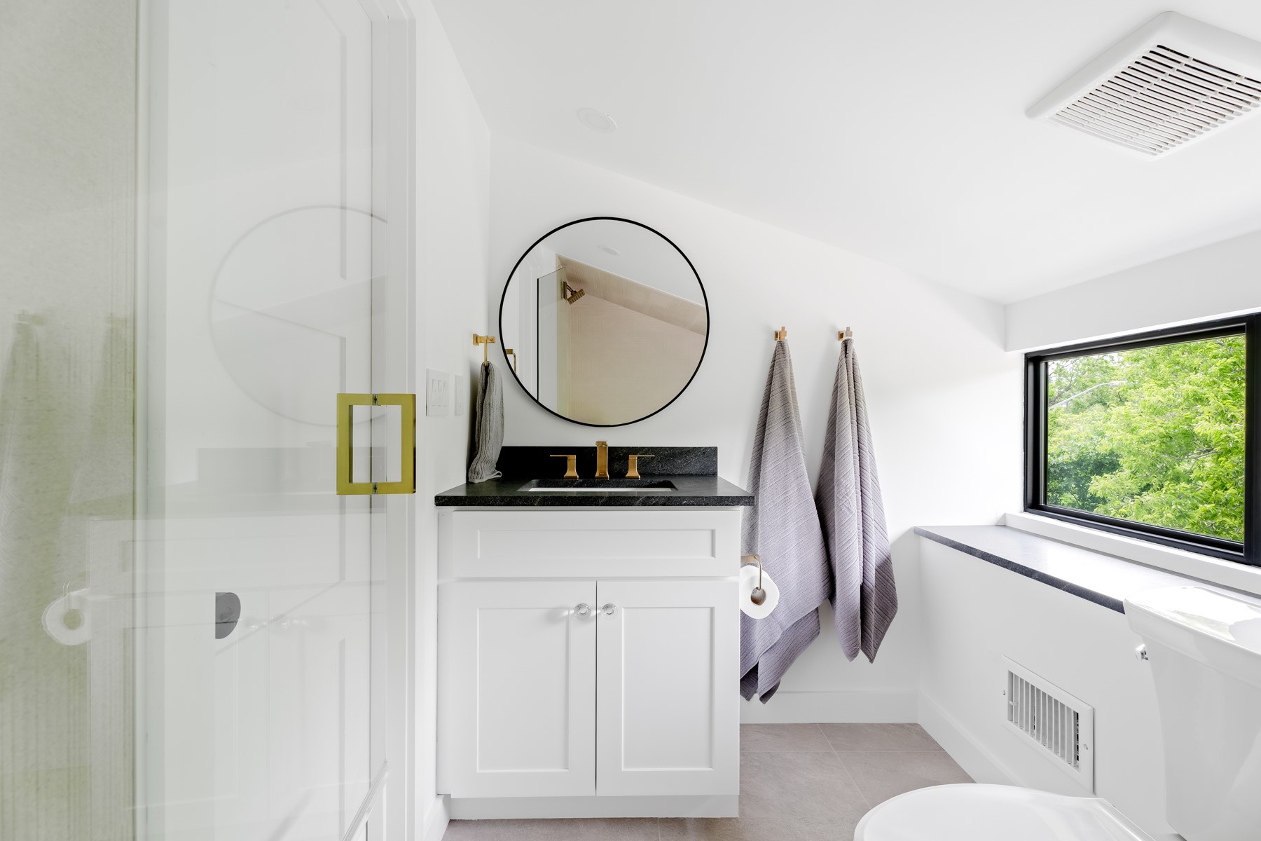 4911 Duval Street Austin, TX 78751 - Photo 20 of 33 a bathroom with a sink a mirror and a toilet