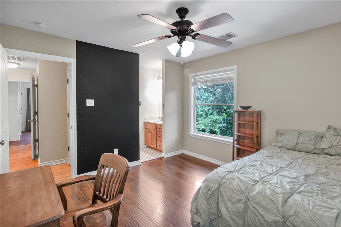 9997 Calhoun Road Bryan, TX 77808 - Photo 16 of 50 a bedroom with a bed and a chair