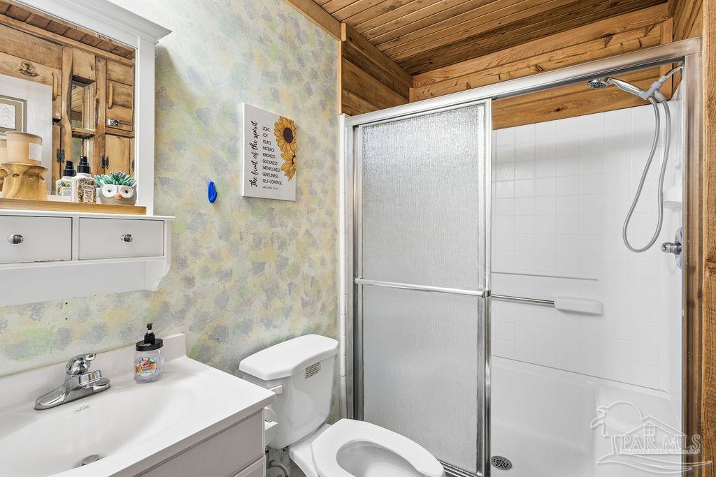 8938 Pioneer Road Holt, FL 32564 - Photo 22 of 44 a bathroom with a sink toilet and shower