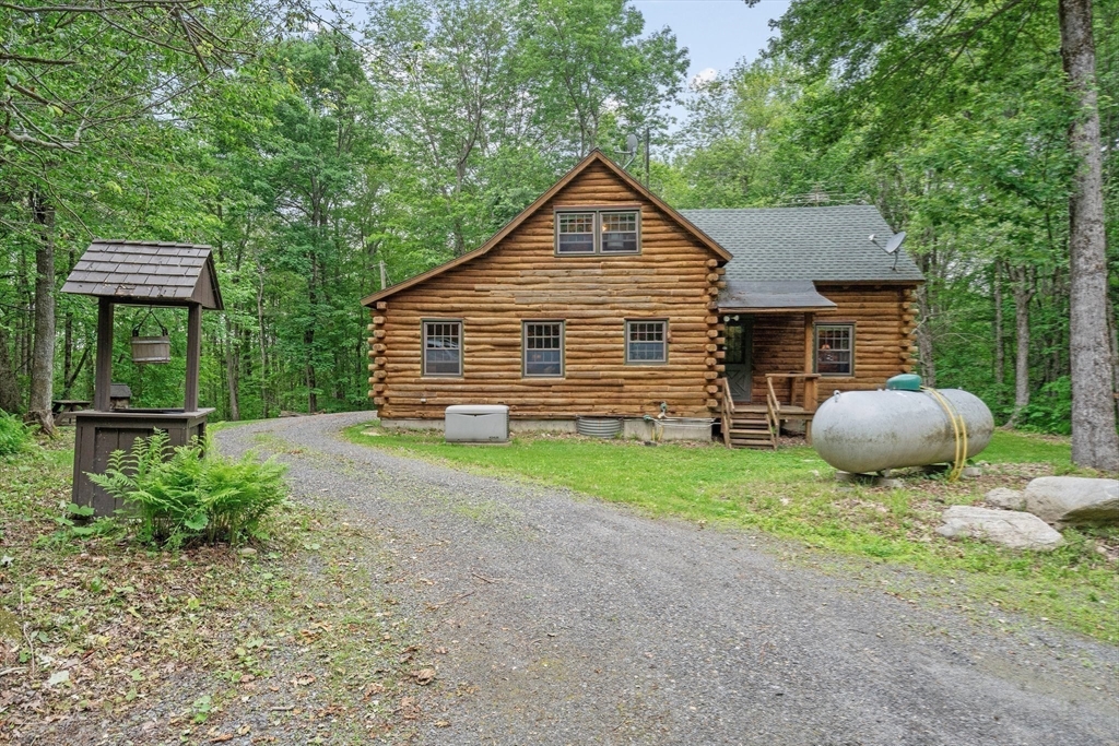 116 Skyline Trail Middlefield, MA 01235 - Photo 30 of 37 a front view of a house with a garden and yard