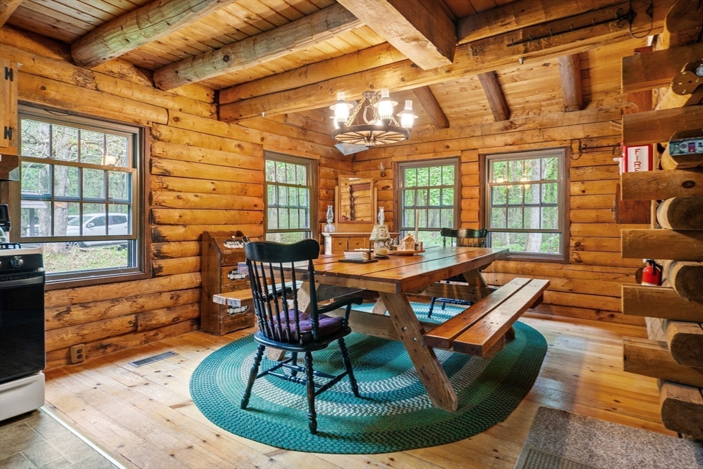 116 Skyline Trail Middlefield, MA 01235 - Photo 8 of 37 a dining room with furniture a chandelier and wooden floor