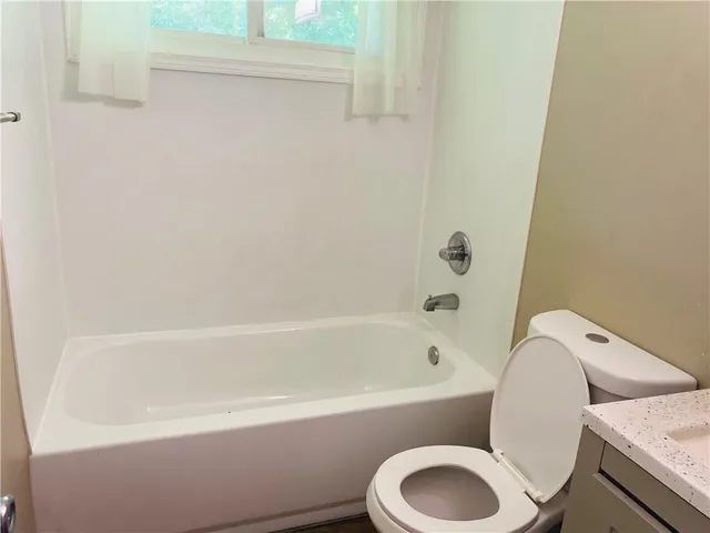 a bathroom with a toilet and a bathtub