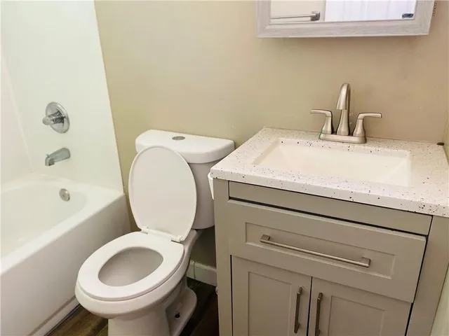 a bathroom with a sink a toilet and a bathtub