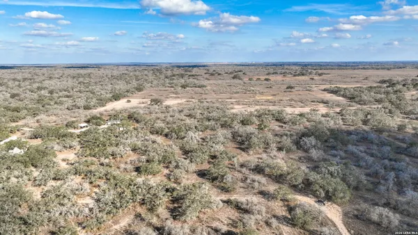 a view of a large building with mountains in the background