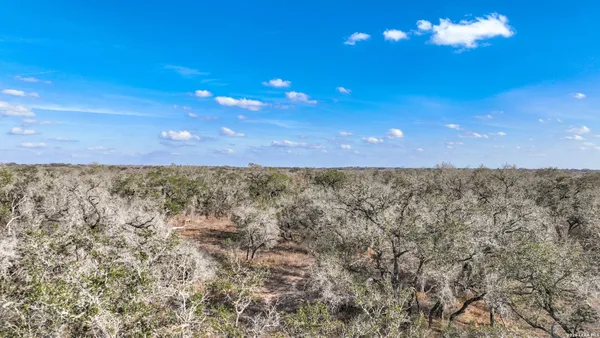 a view of a room with an empty space and a window