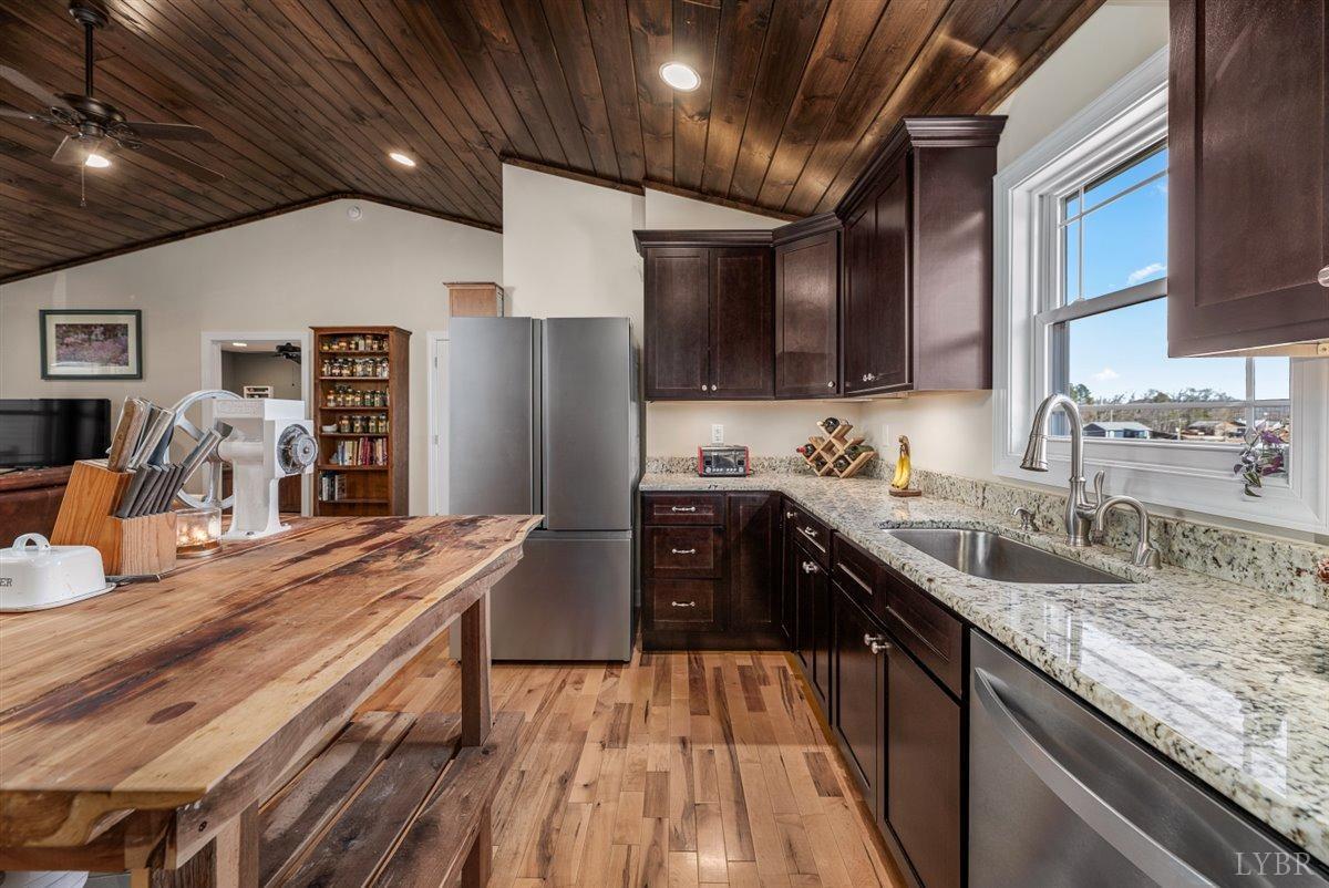 4625 Lowry Road Goode, VA 24556 - Photo 12 of 56 a kitchen with stainless steel appliances granite countertop a sink stove and cabinets