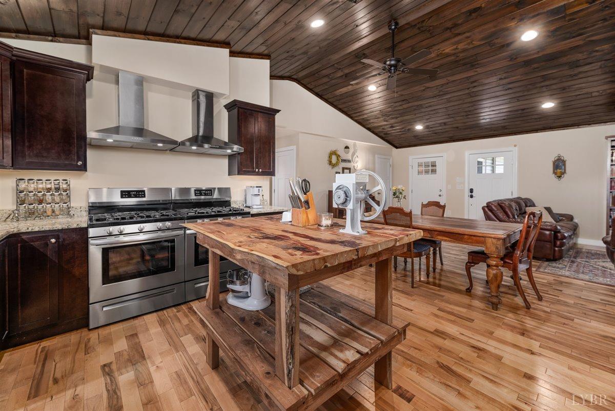 4625 Lowry Road Goode, VA 24556 - Photo 13 of 56 a kitchen with stainless steel appliances a stove a sink dishwasher a microwave oven with cabinets and wooden floor