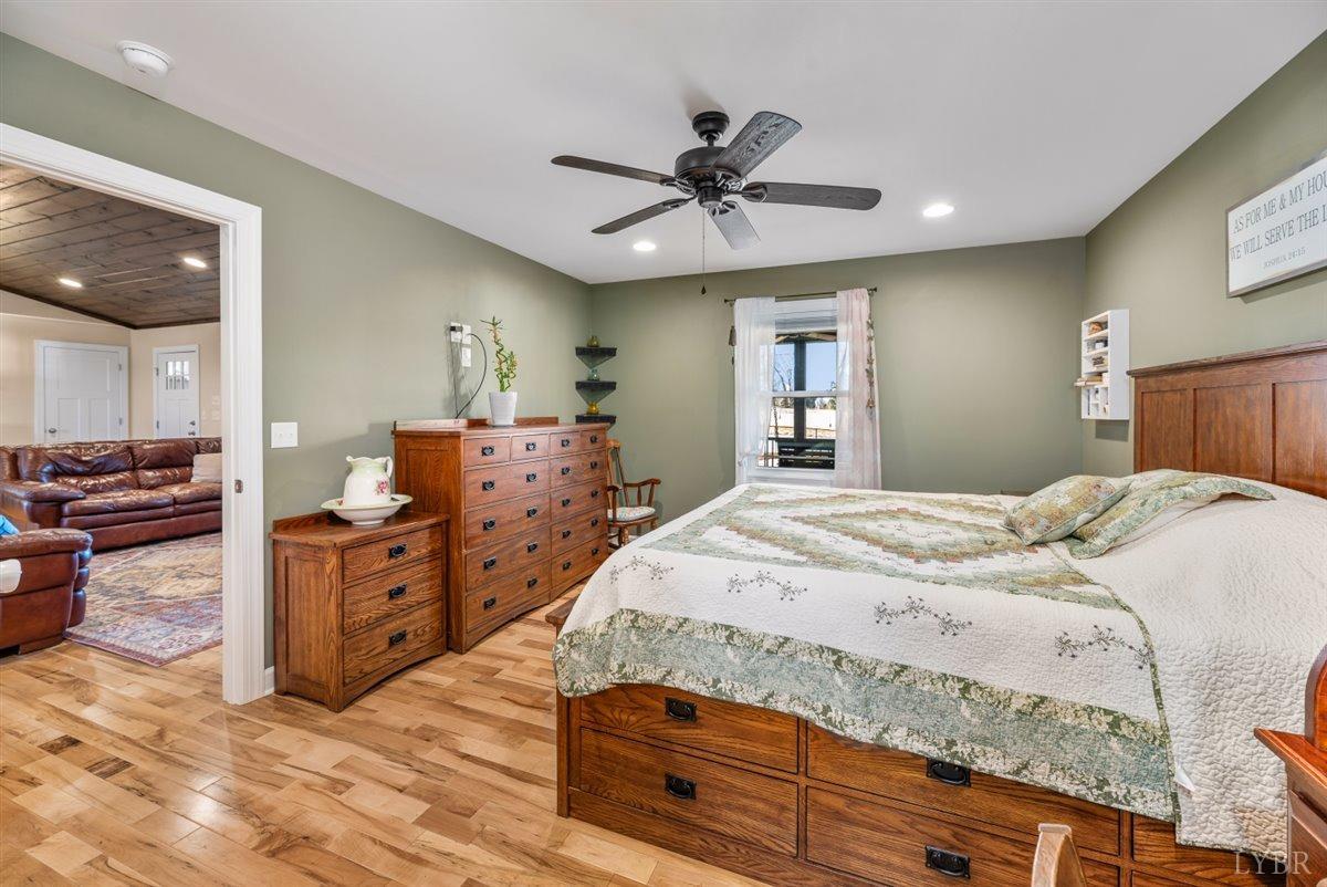 4625 Lowry Road Goode, VA 24556 - Photo 15 of 56 a bed room with a bed and a dresser