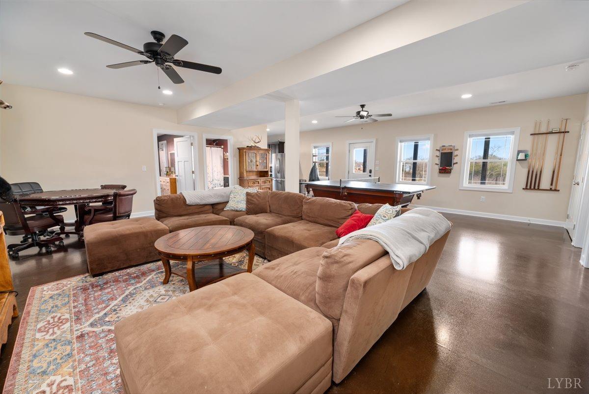 4625 Lowry Road Goode, VA 24556 - Photo 30 of 56 a living room with furniture kitchen view and a chandelier