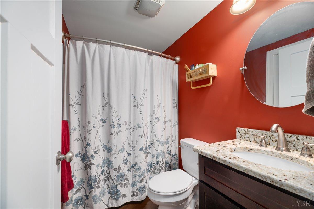 4625 Lowry Road Goode, VA 24556 - Photo 40 of 56 a bathroom with a granite countertop sink toilet and shower