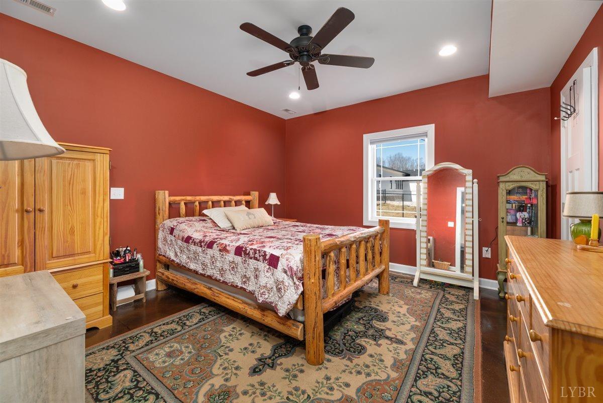 4625 Lowry Road Goode, VA 24556 - Photo 41 of 56 a bedroom with a bed and wooden floor