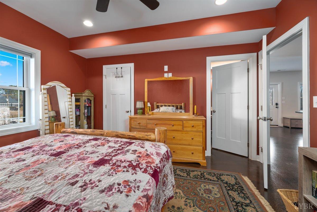 4625 Lowry Road Goode, VA 24556 - Photo 42 of 56 a bedroom with a bed and a dresser with mirror