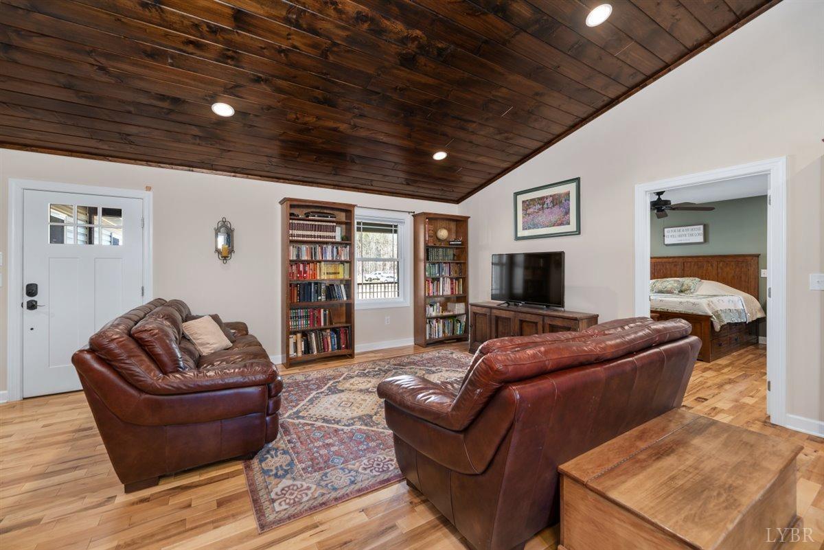 4625 Lowry Road Goode, VA 24556 - Photo 9 of 56 a living room with furniture and a flat screen tv