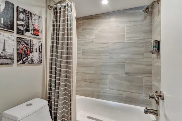 a bathroom with a shower and a toilet