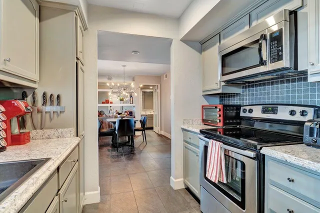 a kitchen with a stove and cabinets