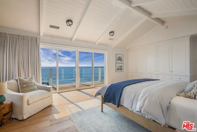 a bedroom with a bed and glass window