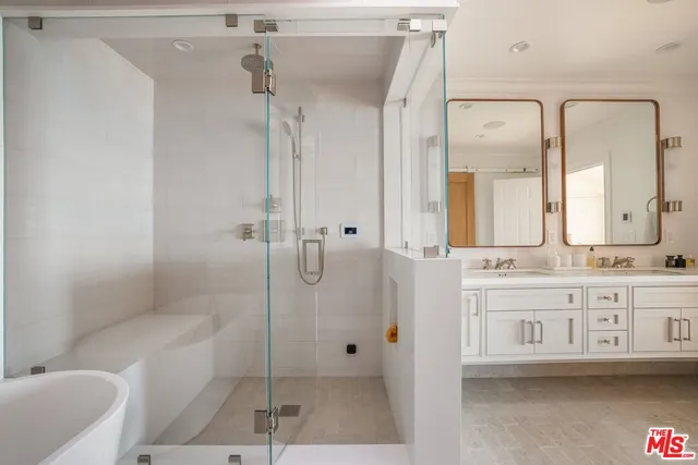 a bathroom with a granite countertop sink a toilet a mirror and shower