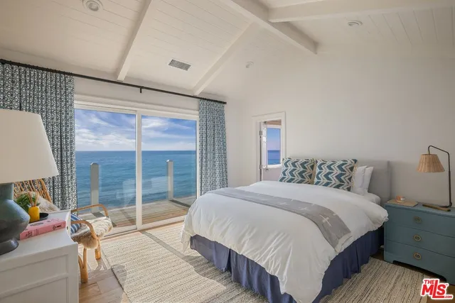 a bedroom with a bed and glass window