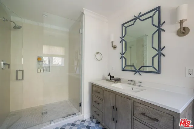 a bathroom with a shower sink and mirror
