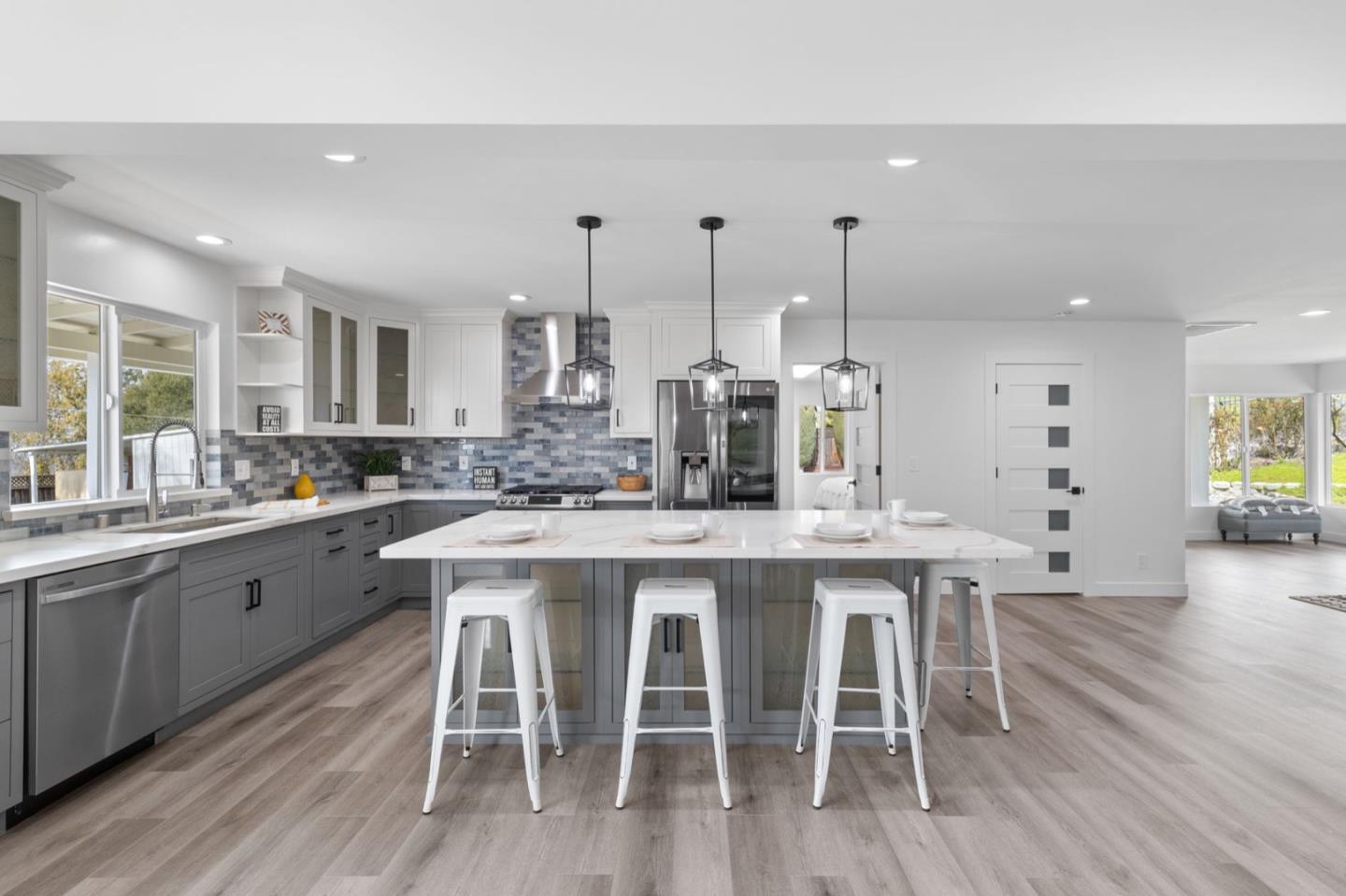 2245 Old Piedmont Road San Jose, CA 95132 - Photo 9 of 39 a kitchen with a dining table chairs wooden floor cabinets and stainless steel appliances