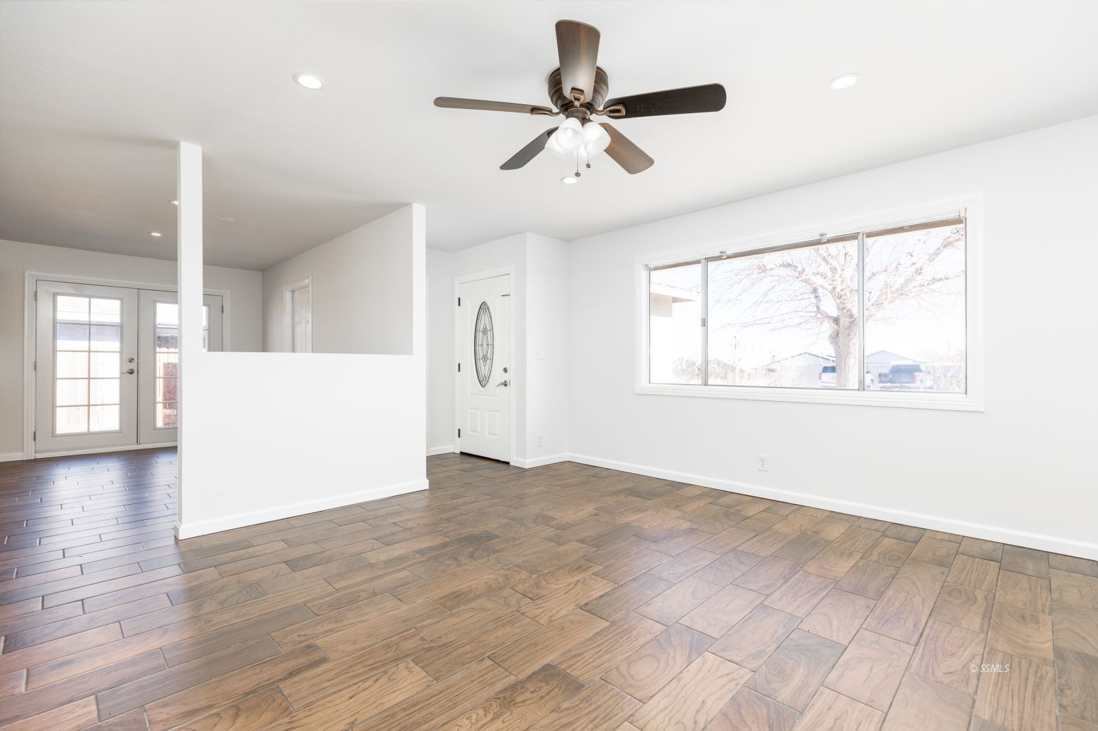 1425 Mayo Street Ridgecrest, CA 93555 - Photo 5 of 28 a view of an empty room with wooden floor and a window