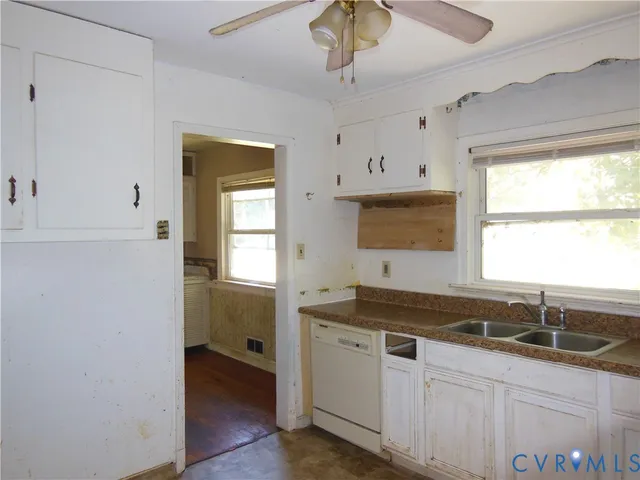 a kitchen with a sink cabinets and window