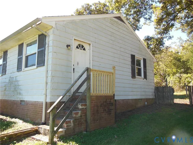 a view of a house with wooden fence