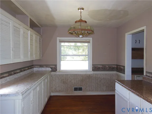 a bathroom with a granite countertop sink a window and tub