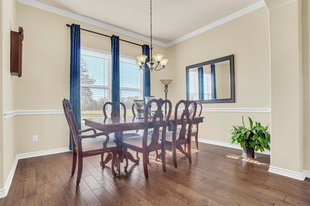 14095 Pecan Lane Forney, TX 75126 - Photo 11 of 34 a view of a dining room with furniture window and wooden floor