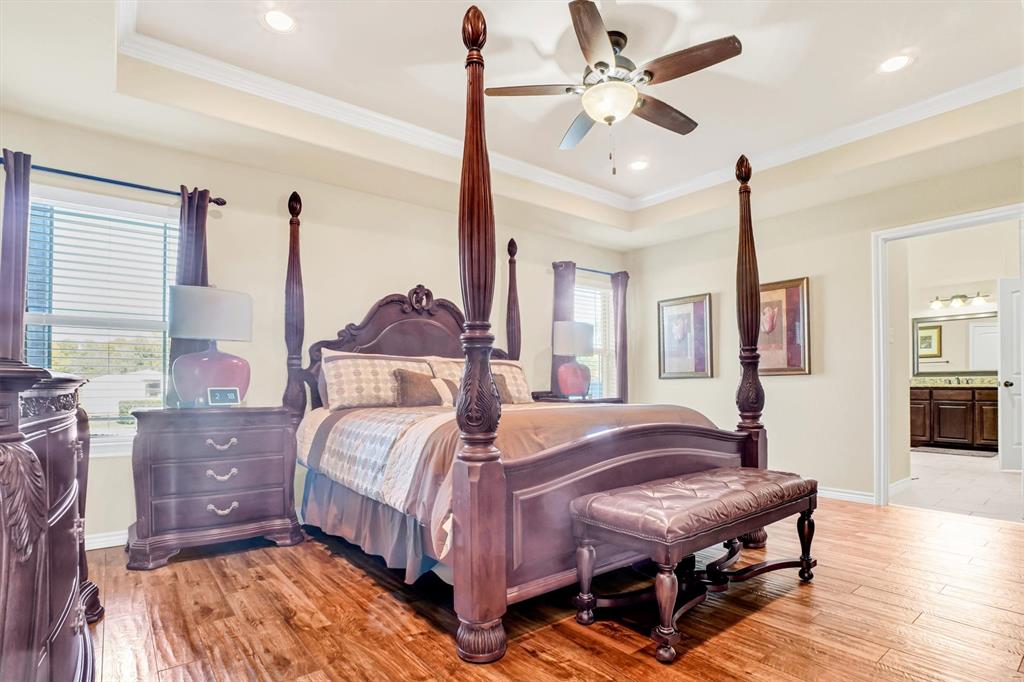 14095 Pecan Lane Forney, TX 75126 - Photo 14 of 34 a bedroom with a bed ceiling fan and a window
