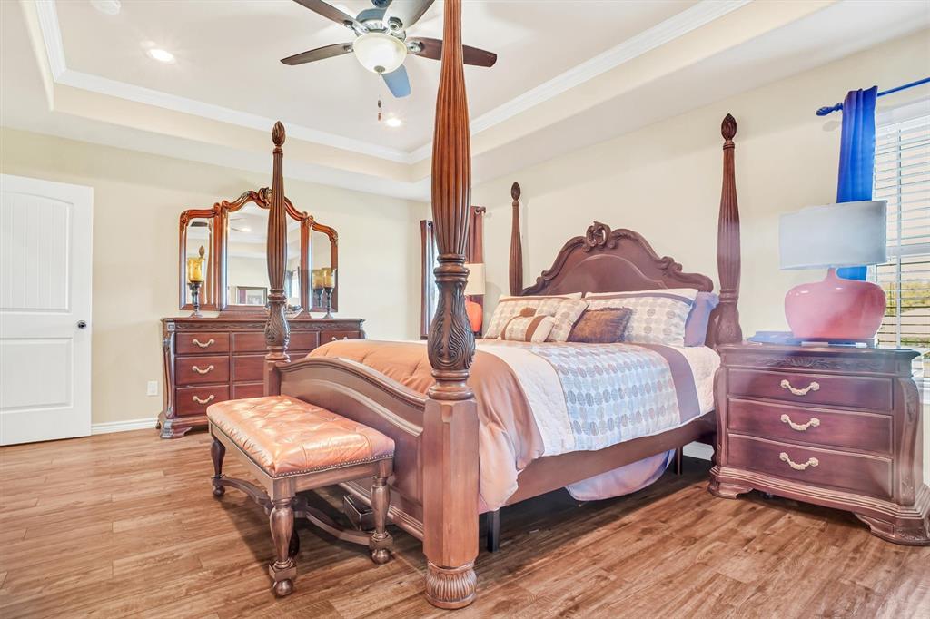 14095 Pecan Lane Forney, TX 75126 - Photo 16 of 34 a bedroom with a bed and wooden floor