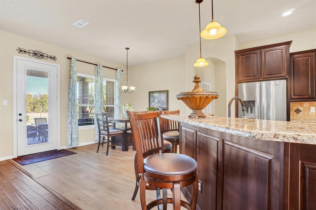 14095 Pecan Lane Forney, TX 75126 - Photo 5 of 34 a kitchen with stainless steel appliances granite countertop a sink a stove and a refrigerator