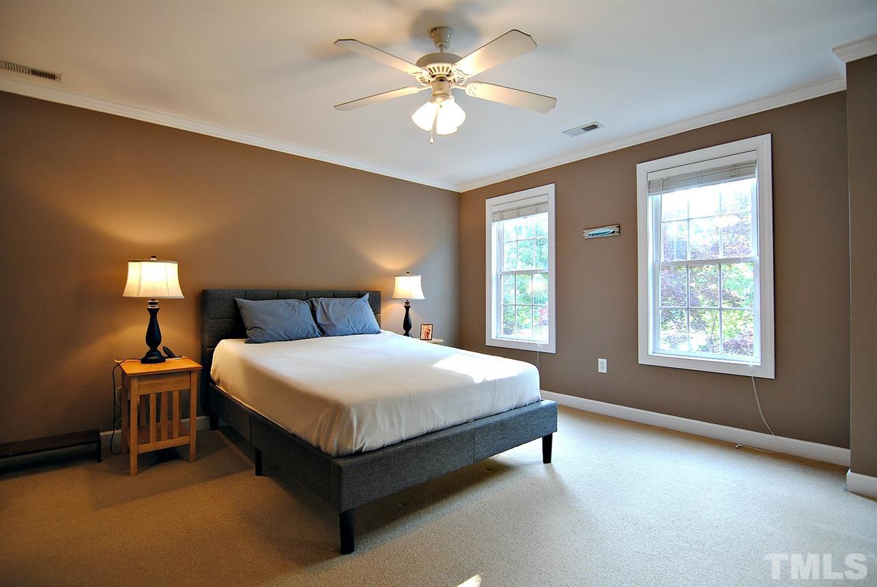 6924 Ray Road Raleigh, NC 27613 - Photo 13 of 22 a bedroom with a bed and a chandelier