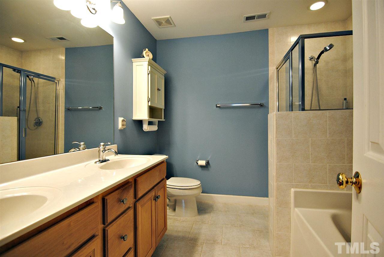 6924 Ray Road Raleigh, NC 27613 - Photo 14 of 22 a bathroom with a sink a toilet and shower