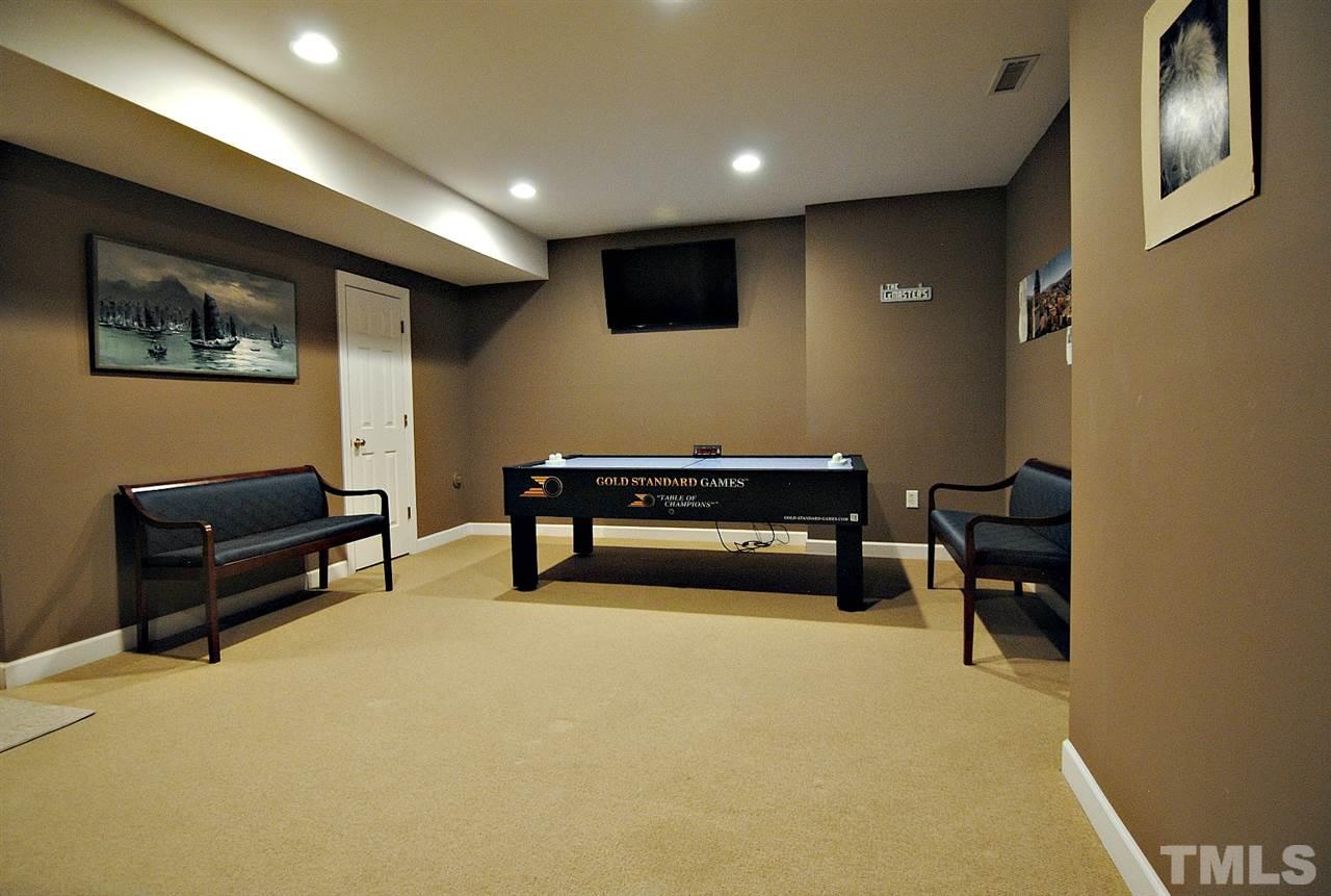 6924 Ray Road Raleigh, NC 27613 - Photo 19 of 22 a living room with furniture and a flat screen tv