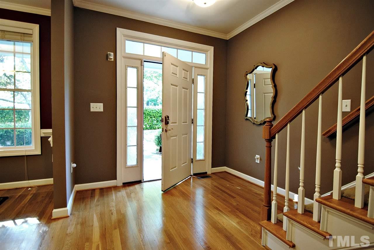 6924 Ray Road Raleigh, NC 27613 - Photo 3 of 22 a view of an entryway with wooden floor and door