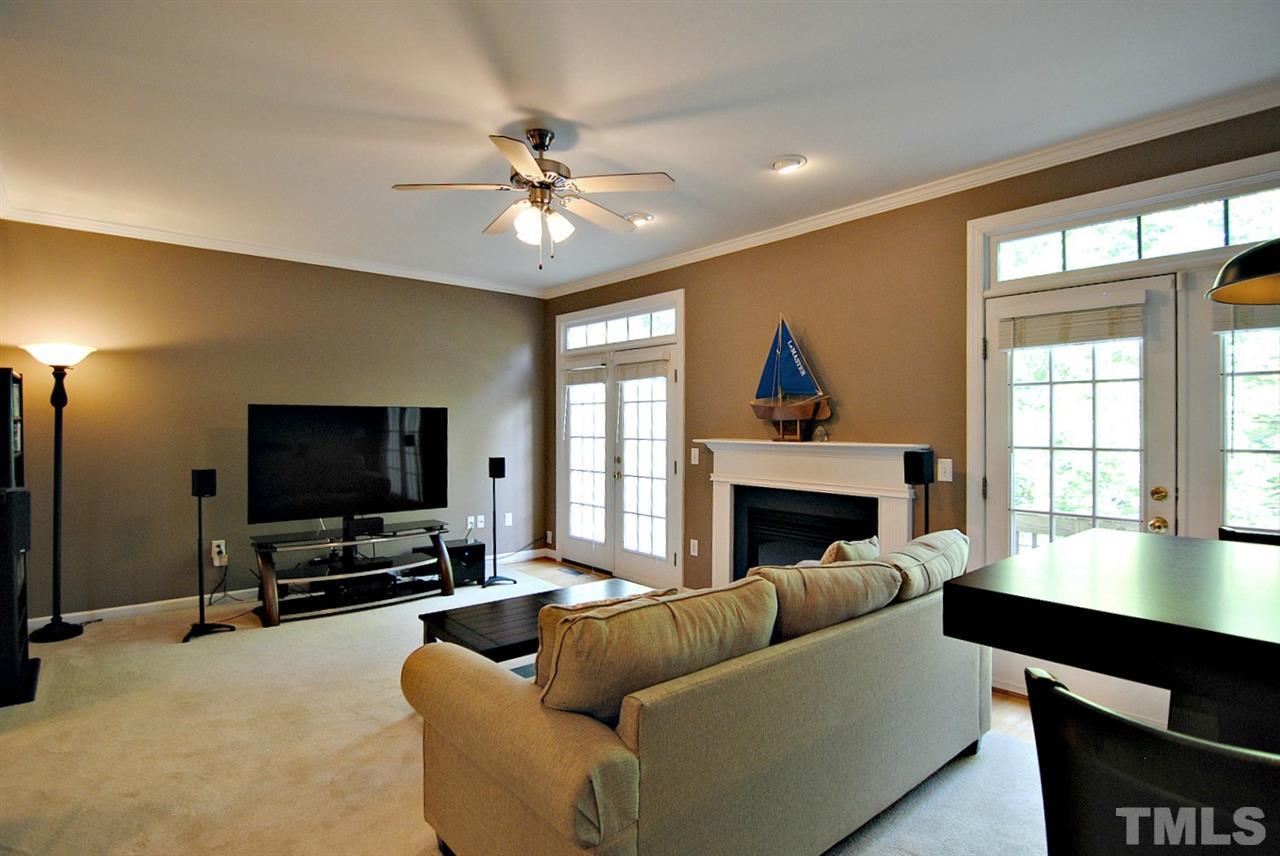 6924 Ray Road Raleigh, NC 27613 - Photo 4 of 22 a living room with furniture a fireplace and a flat screen tv
