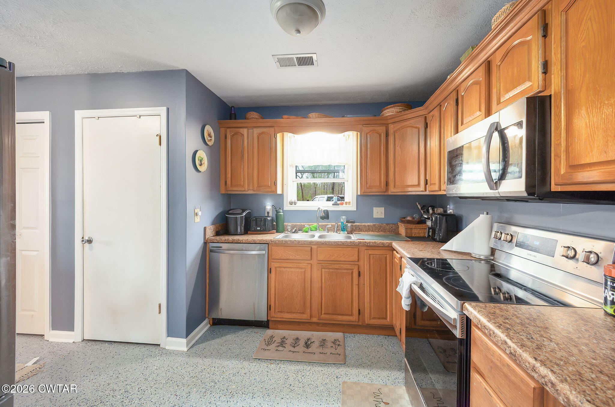 64 Ellendale Place Jackson, TN 38305 - Photo 2 of 19 a kitchen with a stove a sink and a refrigerator
