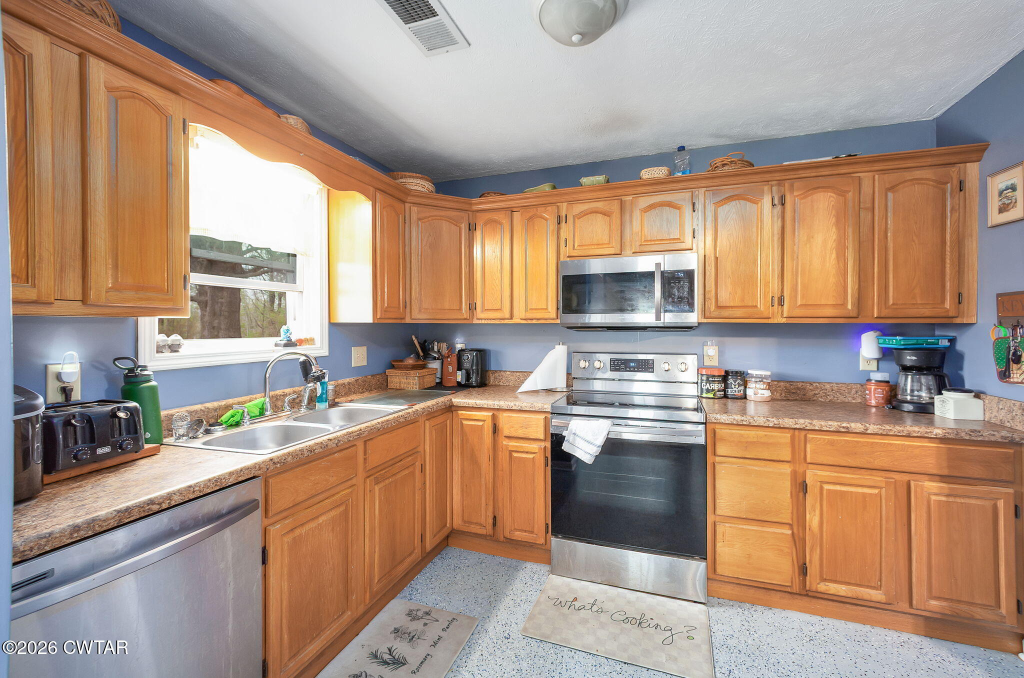 64 Ellendale Place Jackson, TN 38305 - Photo 3 of 19 a kitchen with stainless steel appliances granite countertop white cabinets granite counter tops and a window