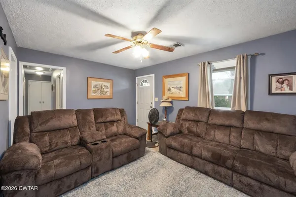 a living room with furniture and a large mirror