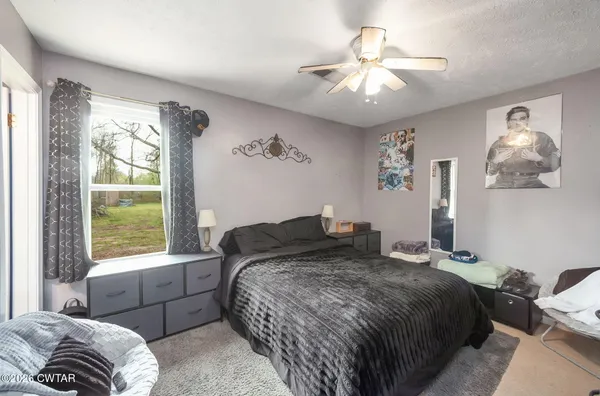 a bedroom with a large bed and a window