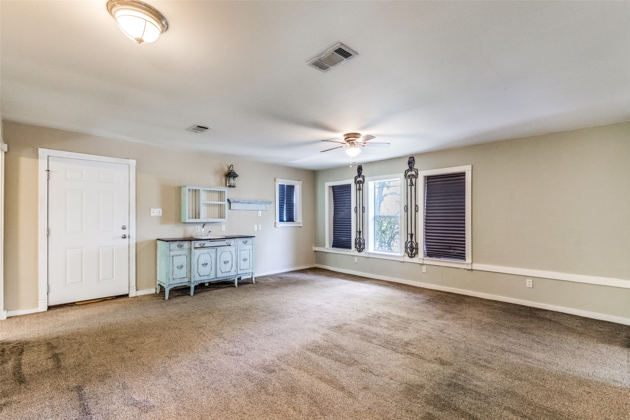 1005 Center Circle Salado, TX 76571 - Photo 16 of 25 Carpet in the large living space U/S. The charming painted sideboard makes a great coffee bar