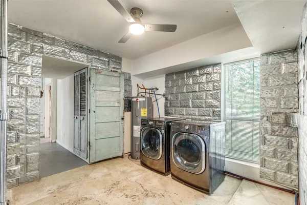an empty room with fan and windows