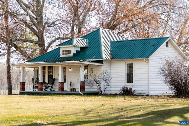 a view of a house with a swimming pool and a tree