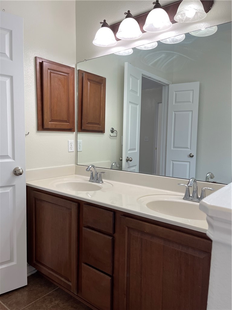1406 Sacramento Street Portland, TX 78374 - Photo 13 of 35 a bathroom with a sink vanity and mirror