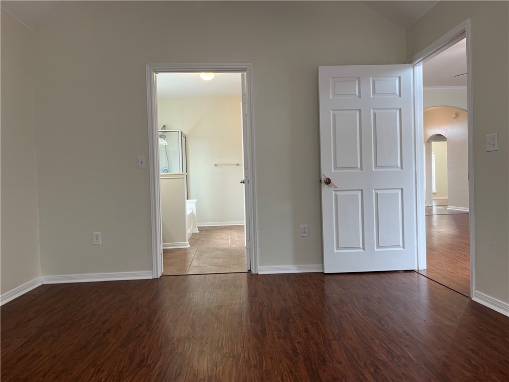 1406 Sacramento Street Portland, TX 78374 - Photo 16 of 35 an empty room with wooden floor and closet